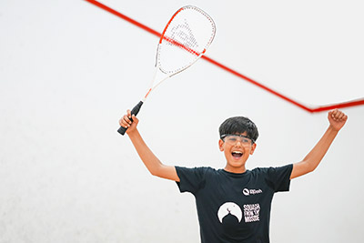 Boy celebrating on a squash court